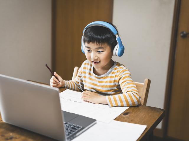 boy with headphones at laptop