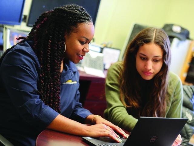 image of advisor working with student at desk with laptop