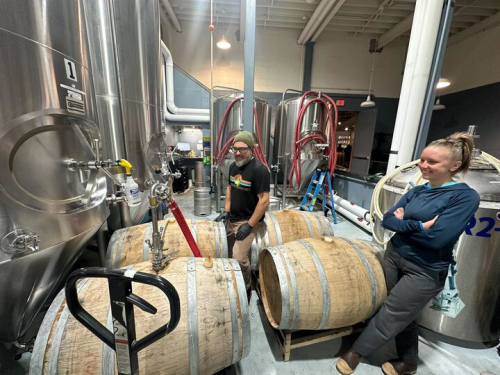 Cathedral Windows exiting barrels after lagering for a month. Strangebird brewers Eric Salazar and Amanda Richardson are pictured.