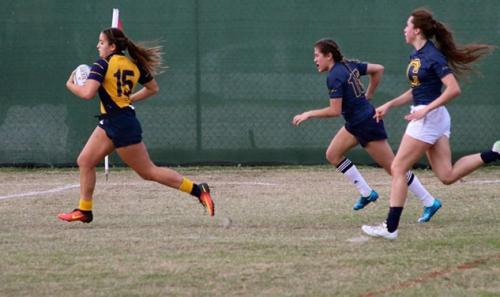 UC Davis post-bac student Gabby Rich runs during a rugby game