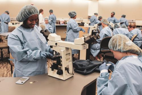 Pre-College students with microscopes