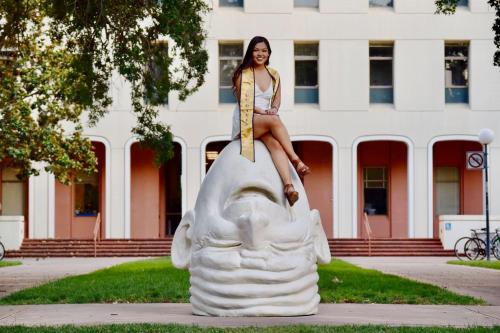 Tiffany Cha sits atop one of Robert Arneson's iconic Eggheads on the UC Davis Campus. 