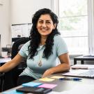 smiling woman at her desk
