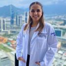 maternal and child nutrition master's student, Sandy Casares, poses with medical coat on